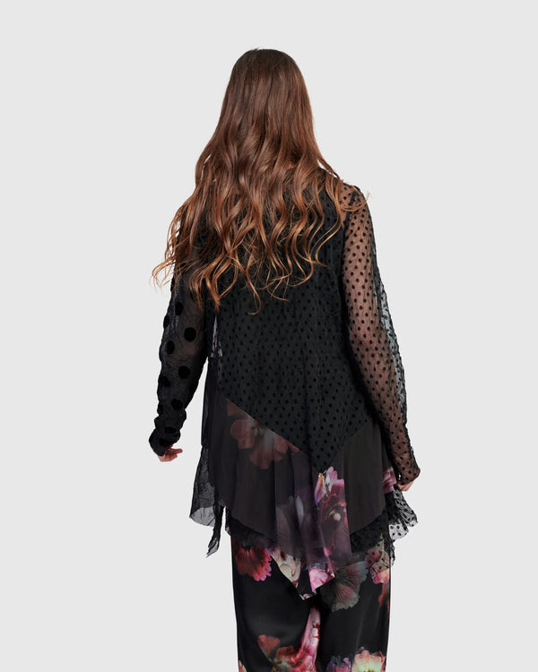 Woman wearing ET136M Fabulous Tunic Top with dark floral print, sheer black lace sleeves, and layered hem - 4