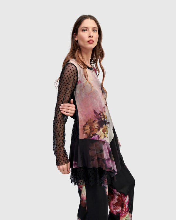 Woman wearing ET136M Fabulous Tunic Top with dark floral print, sheer black lace sleeves, and layered hem - 3
