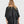 Load image into Gallery viewer, Woman wearing black taffeta butterfly top with flared sleeves and gathered waist paired with dark cargo pants - 3
