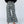 Load image into Gallery viewer, Woman wearing TBN6292 Wanderer Wide Leg Camo Pants with black top and layered necklaces, wide leg silhouette - 3
