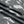 Load image into Gallery viewer, Woman wearing gray camouflage cargo jogger pants with patch pockets and white crop top, casual street style outfit - 5
