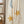 Load image into Gallery viewer, Cream wide leg lounge pants with sun, moon, and star print, styled with rust cardigan and light blue crop top outdoors - 5
