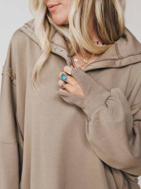 Woman wearing oversized taupe quarter-zip pullover sweatshirt with exposed seams and ribbed cuffs - 4