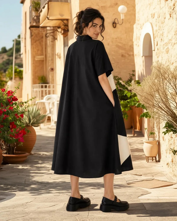 Woman wearing black and cream colorblock button-down midi shirt dress with geometric pattern and short sleeves - 3
